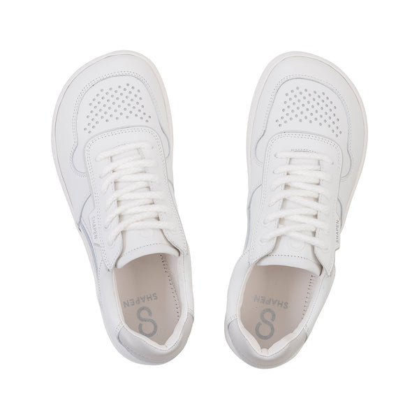 Pair of white sneakers on a white background